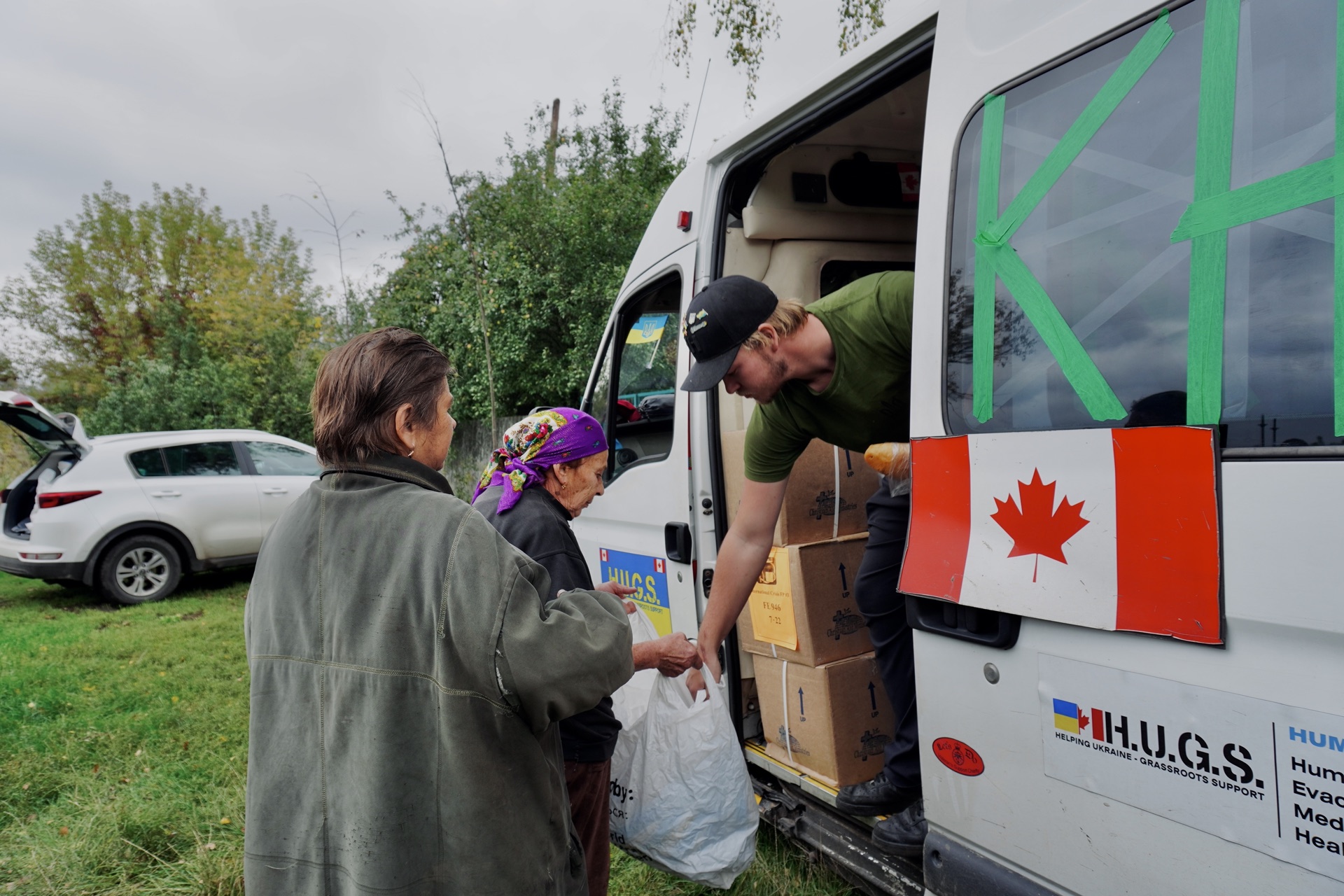 Distributing food and supplies from a HUGS humanitarian van to local residents in the Kharkiv region