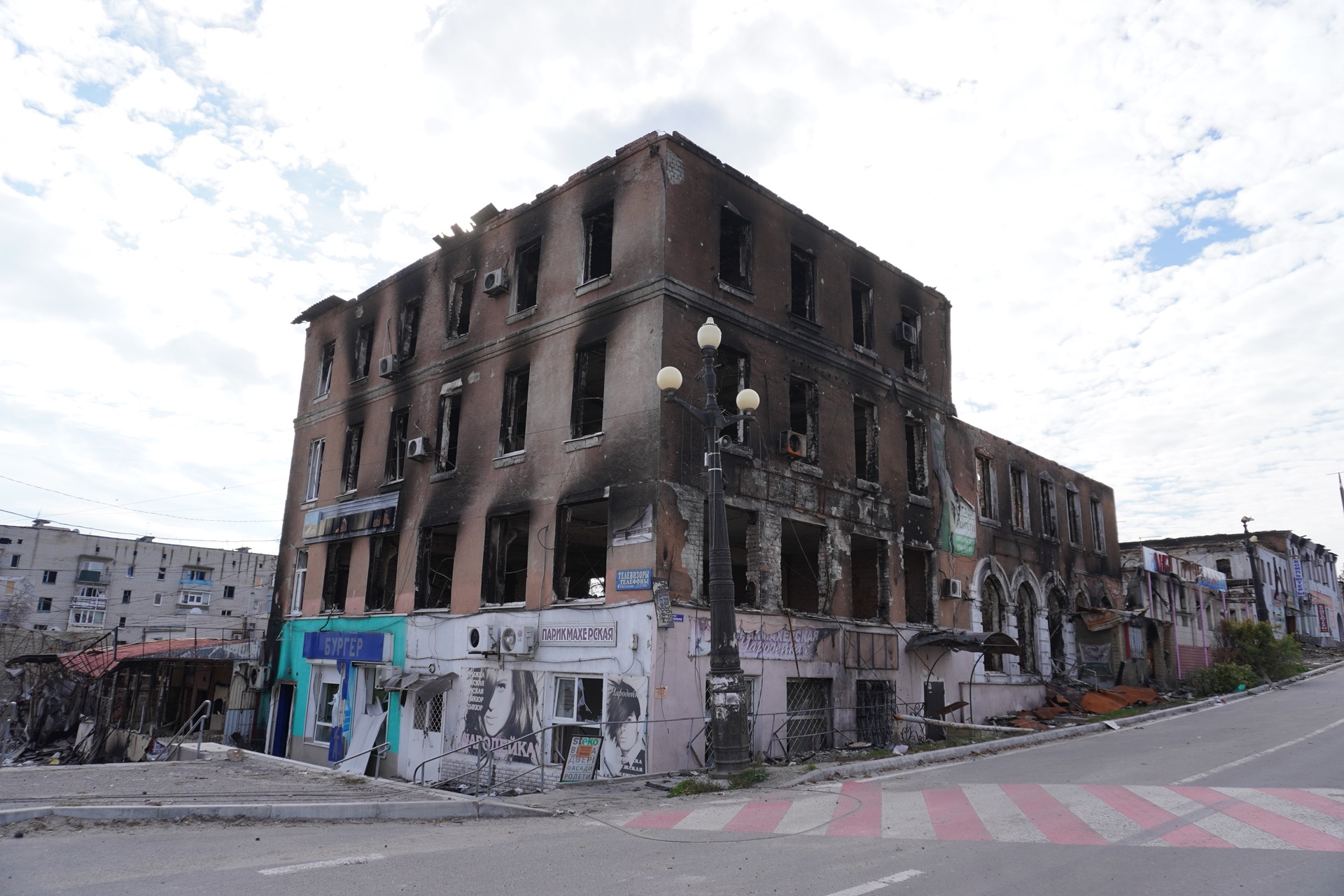 A fire-gutted building on a deserted street in Kupiansk following the Russian invasion