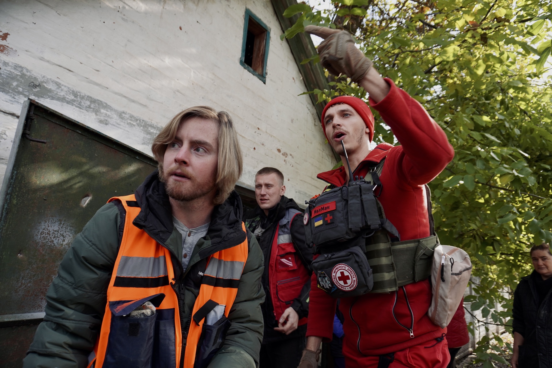 A humanitarian worker alongside a Red Cross medic during a mission near Pershotravneve